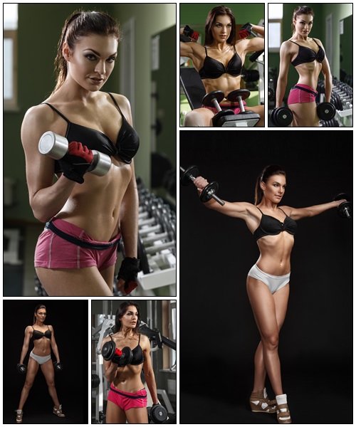 Woman bodybuilder training with dumbbell - Stock Photo